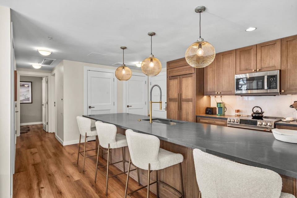The newly updated designer kitchen features an induction oven, sub-zero fridge and large breakfast bar for 4.