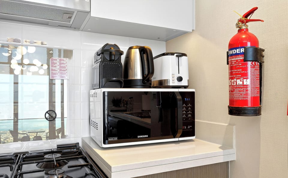 Standard Apartment, Sea View | Private kitchen | Toaster, cleaning supplies, freezer, dining tables
