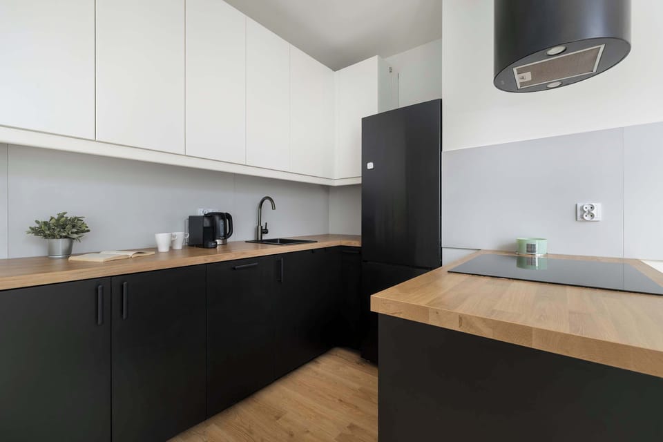 The sleek design of the kitchenette blending seamlessly with the living area.