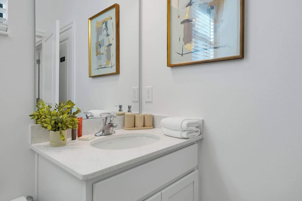 Refresh at the pristine quartz vanity, fully stocked with fresh towels for your stay.