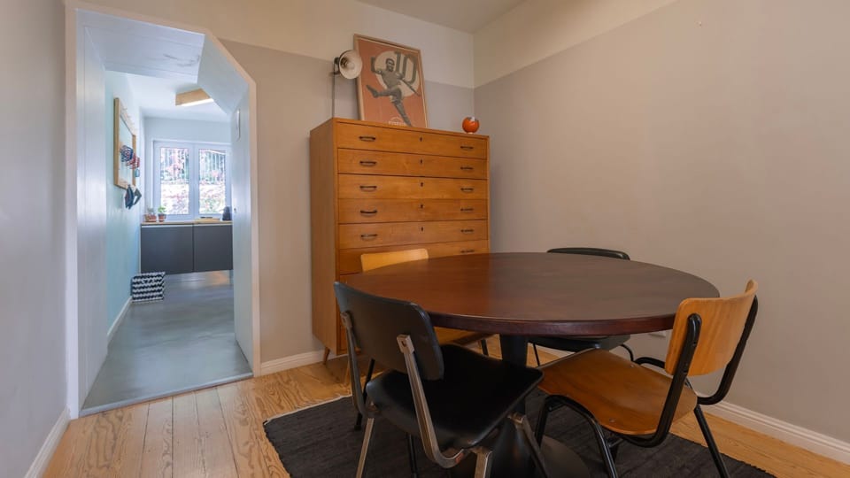 Discover charming details in this attic bedroom, where the open skylight invites the sky inside and a rustic wooden beam adds architectural character. This cozy nook is perfect for thoughtful moments or enjoying the unique perspective of the city rooftops