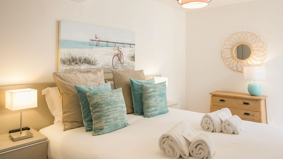 A serene double bedroom with fresh linens, soft aqua details and a calm, contemporary feel for restful nights in the city. #DoubleBedroom #GracaLisbon #CityBreak #portugal #pt #lisbon