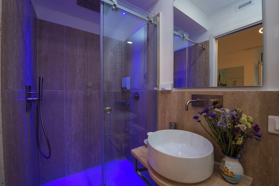 Family Quadruple Room, 1 Bedroom, Balcony, City View | Bathroom shower