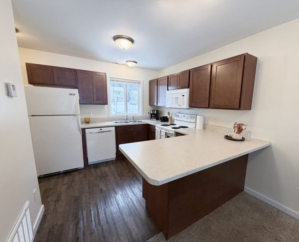 Another angle of the full kitchen bright clean and ready for late night snacks