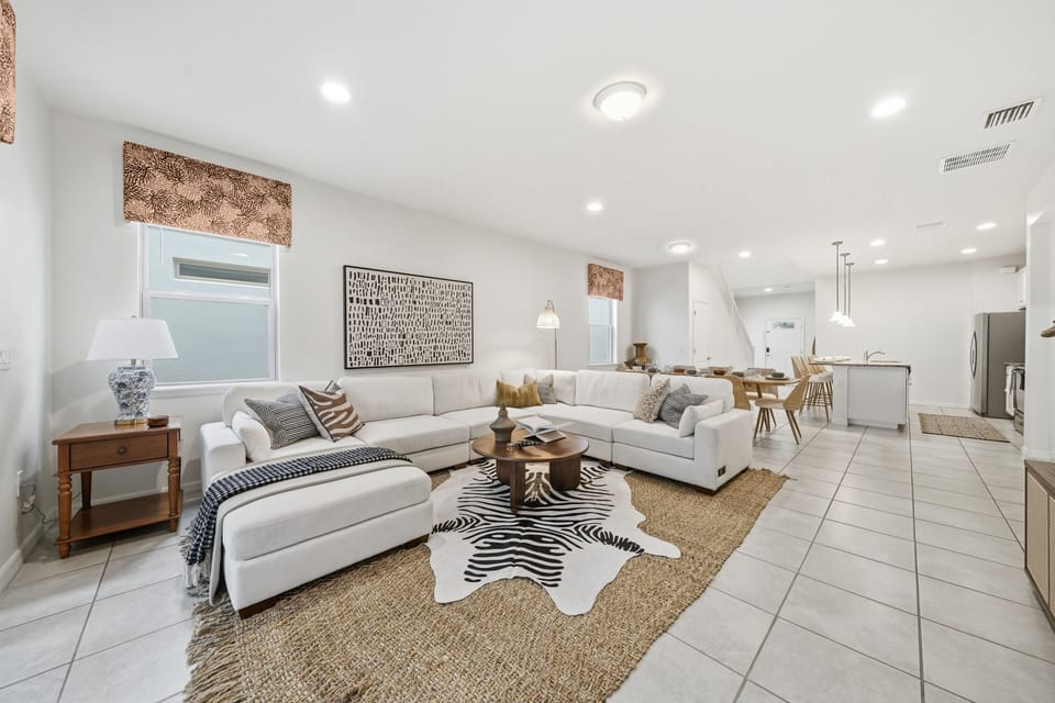 Open floor plan concept featuring the living room, dining area + kitchen