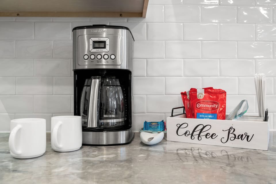 Stylish coffee bar with drip maker, mugs, and fixings — brew-ready and the perfect way to start your day in Inlet Beach!