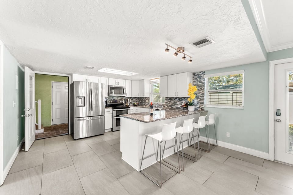 Downstairs Unit 1: Kitchen that Opens to Sauna & Pool Area