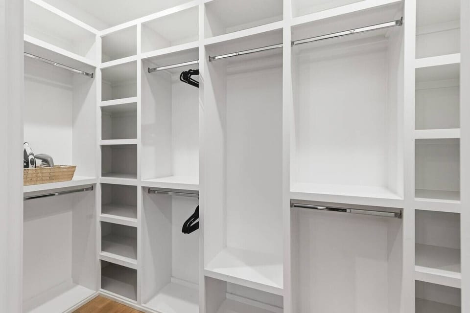 Primary bedroom with king-sized bed, huge walk-in closet, Smart TV, and ensuite full bathroom. Located on the 2nd floor.
