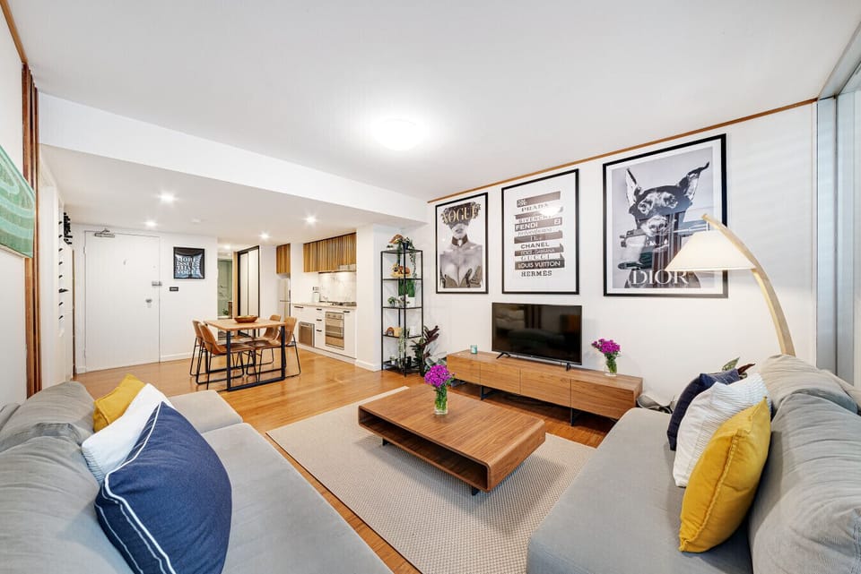 Open plan living room with floor fan and dining space