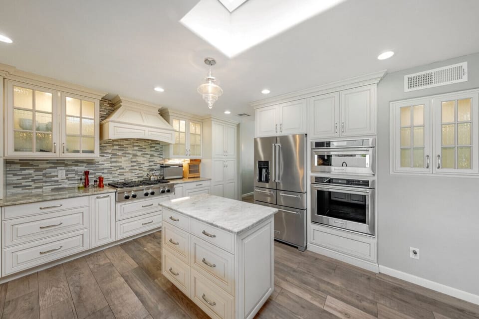 Beautiful kitchen with upgraded appliances, island, plenty of counter space and storage, and seating at the peninsula