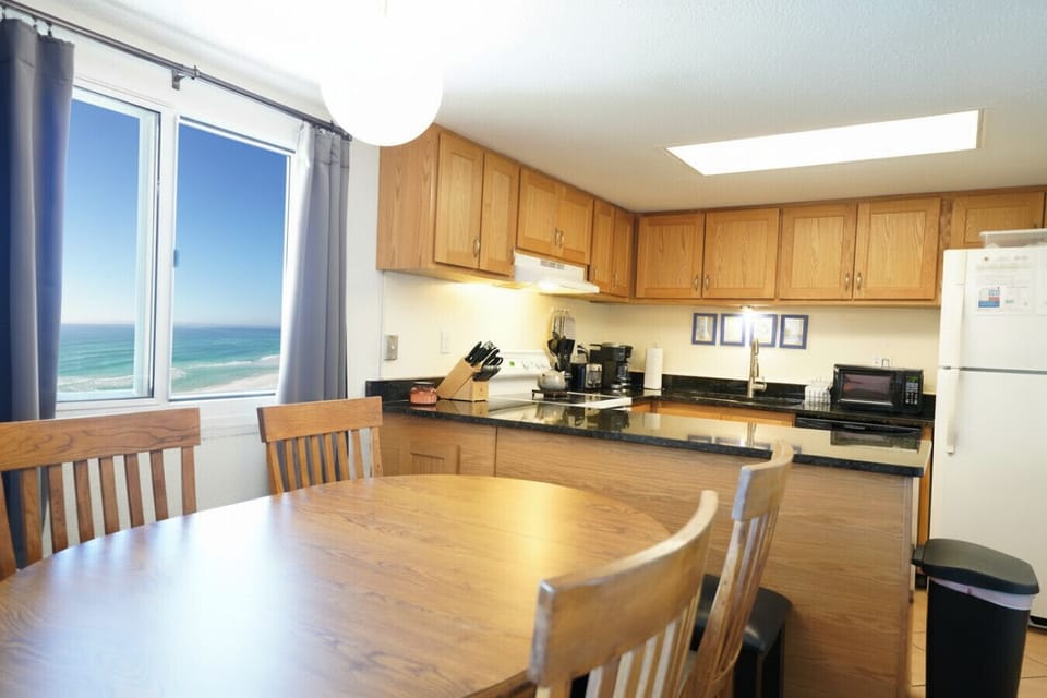 Well-appointed kitchen featuring granite surfaces and modern appliances. Enjoy privacy and quality with inspiring ocean views.