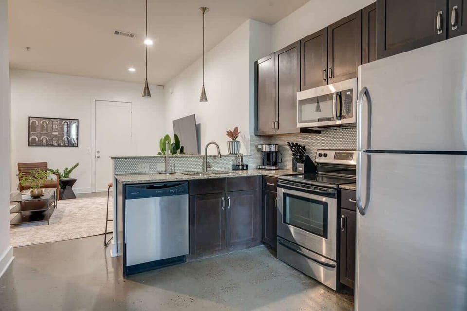 Unit 2: Fully equipped kitchen stocked with basic cooking essentials and complete with bar seating.