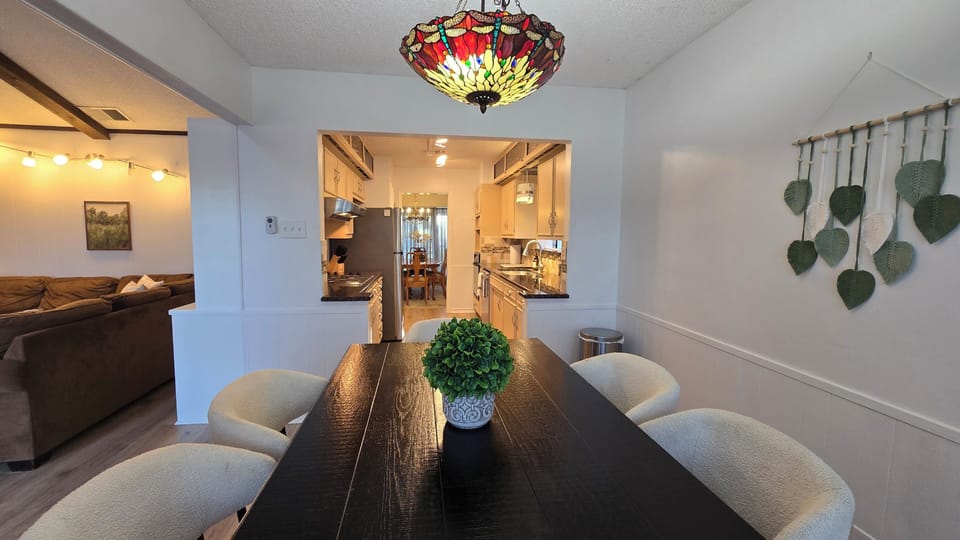 Additional dining table with seating for 6 overlooking kitchen and living room.