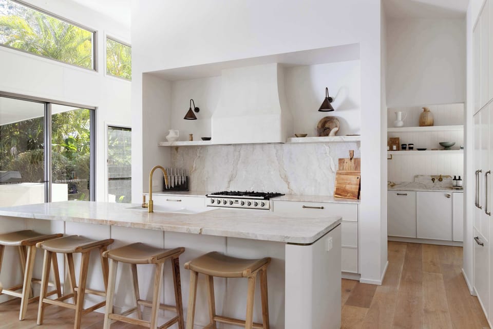 Entertain with ease in the chef’s kitchen, featuring a marble splashback, premium appliances, and a generous island bench.