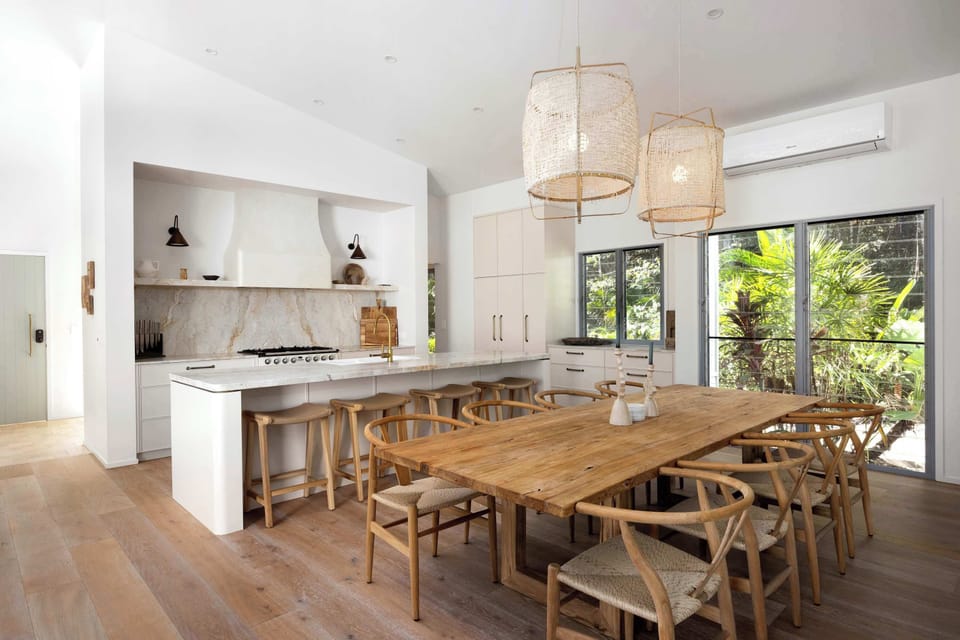 Host memorable dinners at the designer dining table, framed by statement lighting and garden views.
