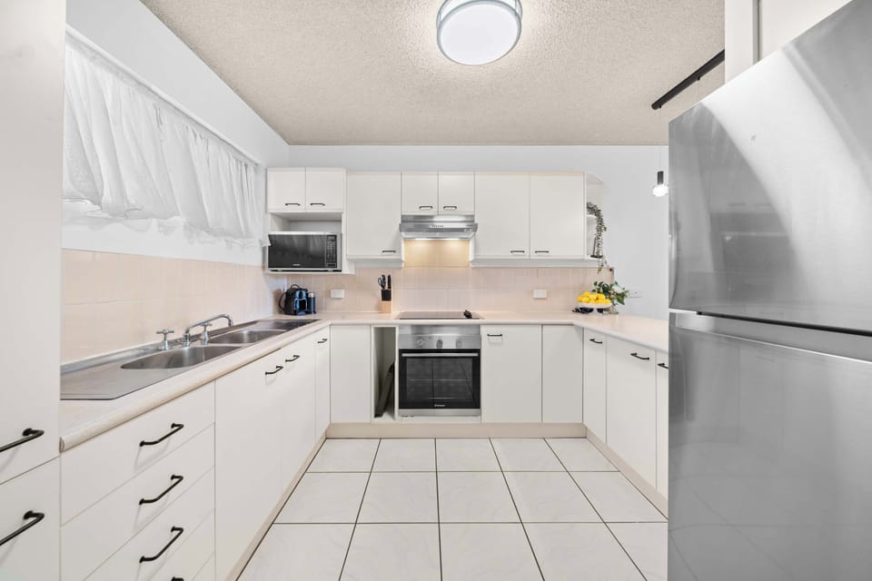 Prepare effortless holiday meals in a bright, fully equipped kitchen where ample bench space, quality appliances, and thoughtful layout make cooking together feel easy and enjoyable.