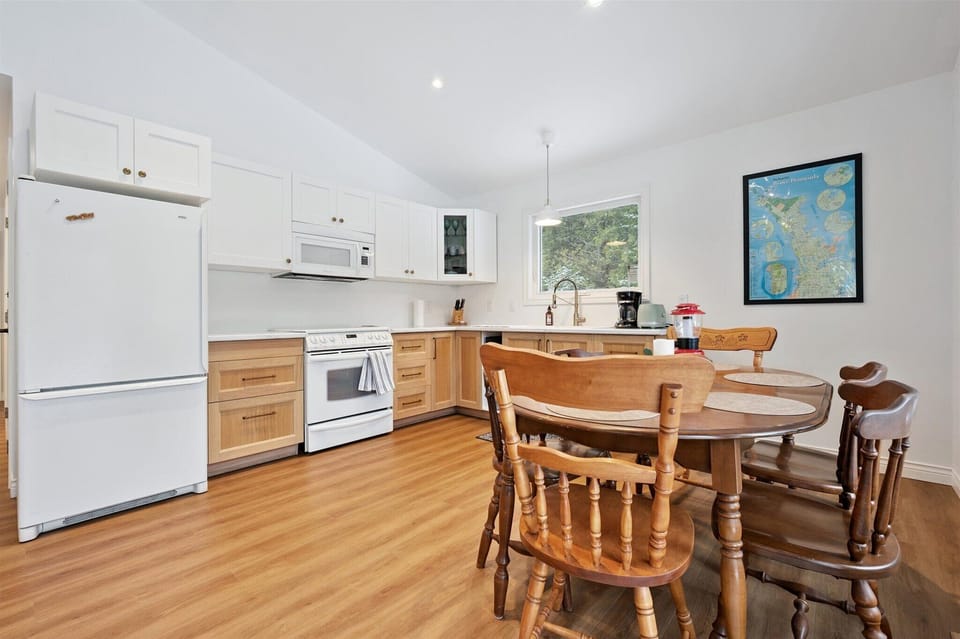 Fully equipped kitchen with modern appliances and ample counter space, designed for easy cottage cooking.
