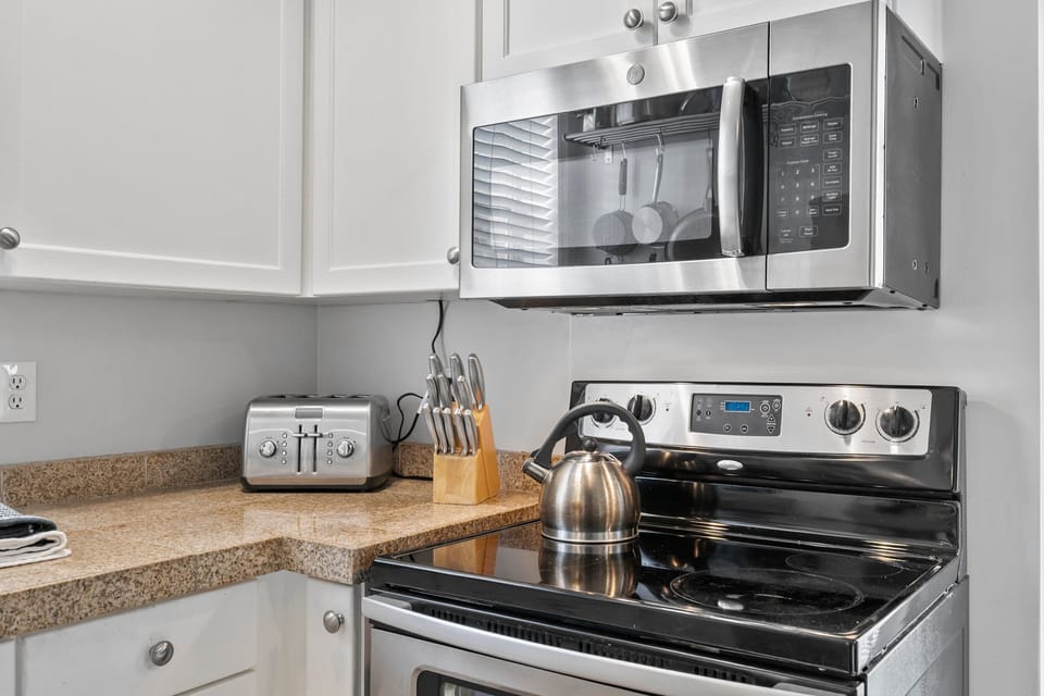 A full Galley Kitchen with dishwasher, Oven/Range, Microwave, Coffee Service and full size refrigerator