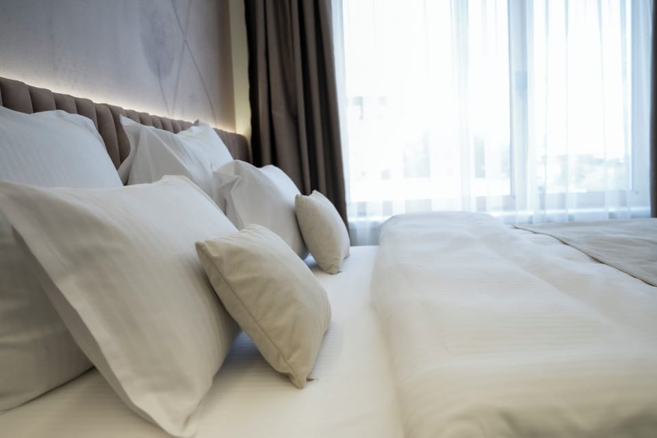 Deluxe Apartment, Balcony, City View | Minibar, in-room safe, laptop workspace, iron/ironing board