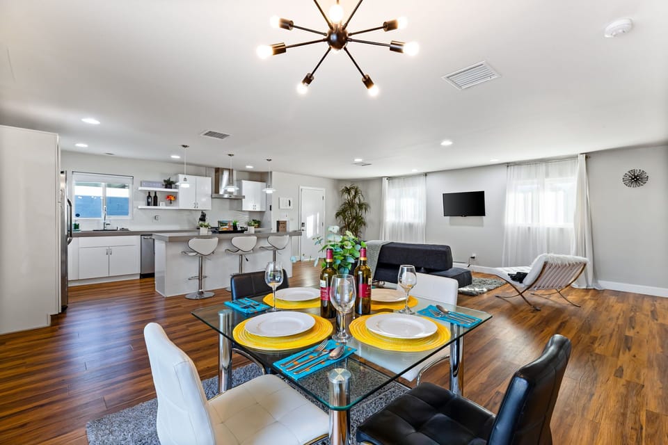 A sleek black-and-white dining space for four, perfect for stylish meals and intimate gatherings.