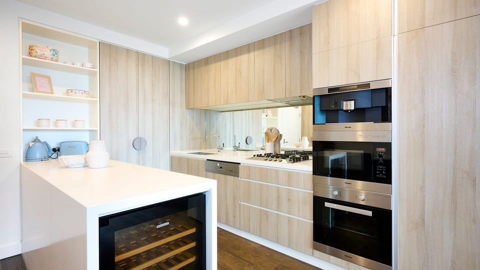 Contemporary kitchen with island bench and wine fridge