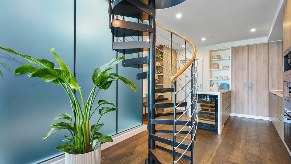 Unique spiral staircase leading to the upper level