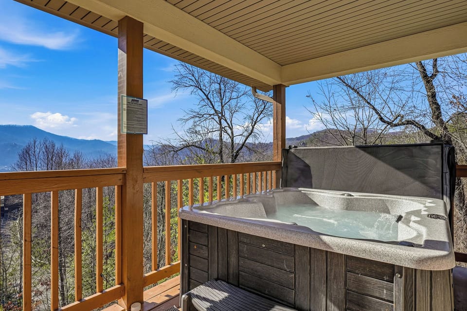 Soak in your private hot tub while taking in breathtaking mountain views from your covered deck.