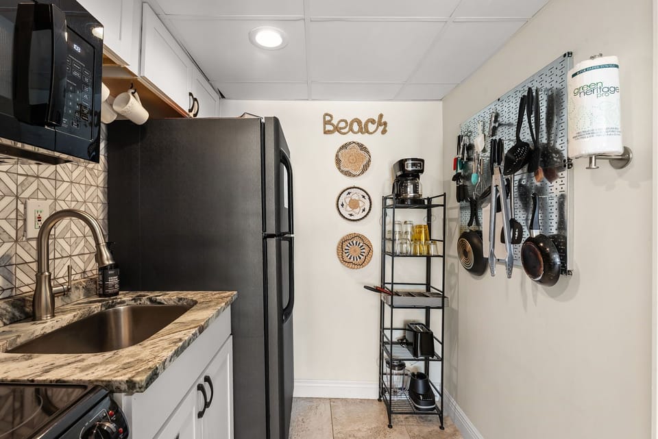 Your fully equipped kitchen features modern appliances and charming beach-themed touches, perfect for preparing meals during your coastal getaway.