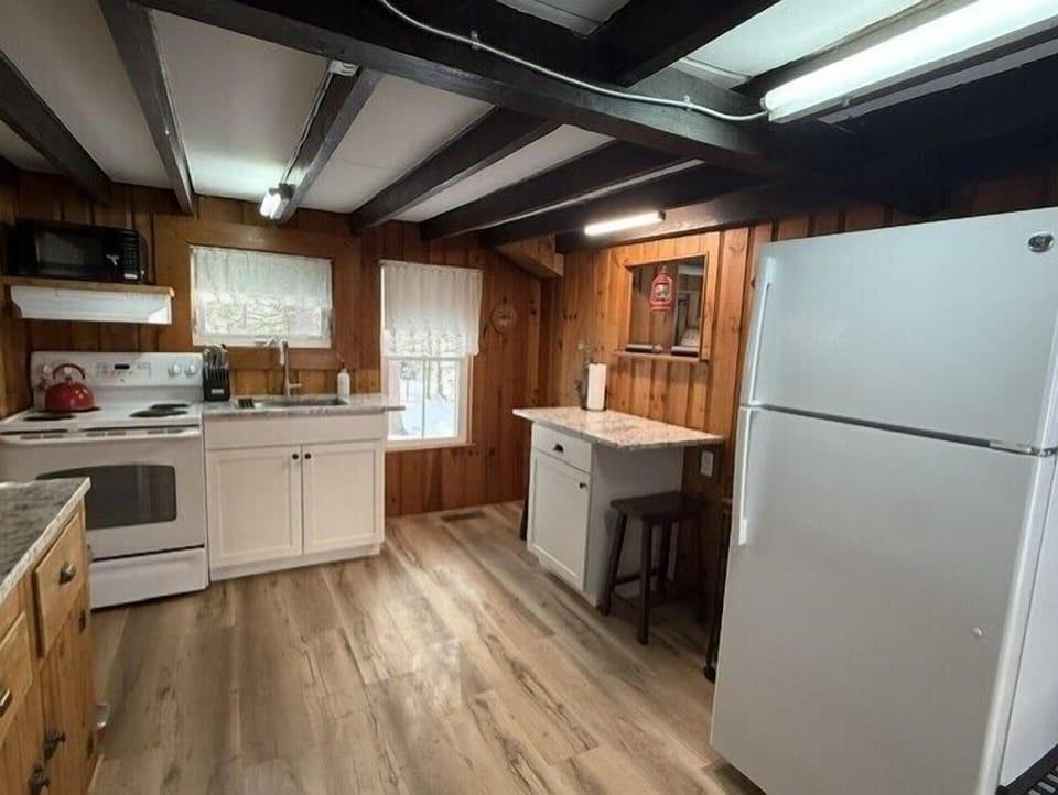 Cook your favorite meals in this charming kitchen featuring modern appliances and rustic wood accents.