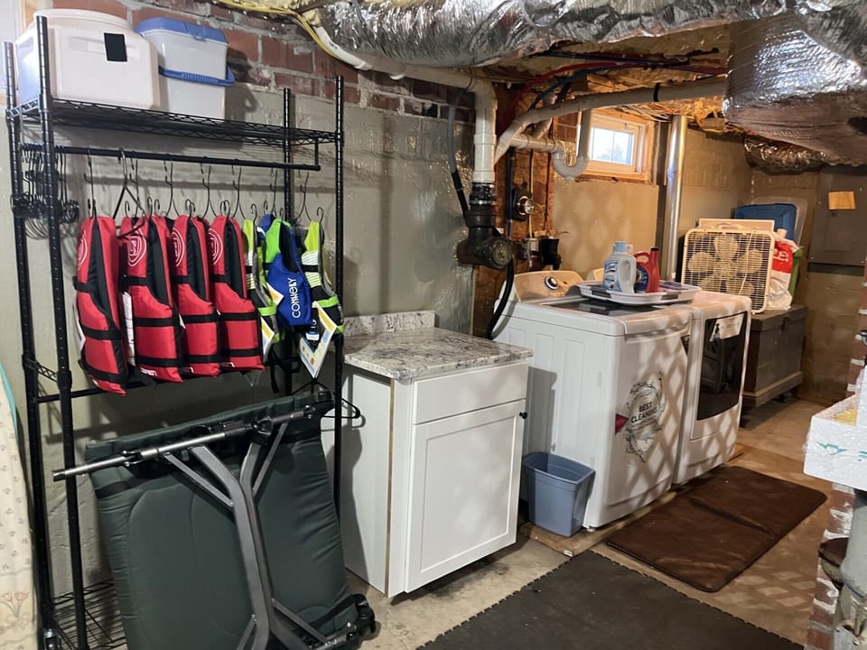 Your dedicated laundry and storage space keeps everything organized, with life jackets ready for lake adventures.