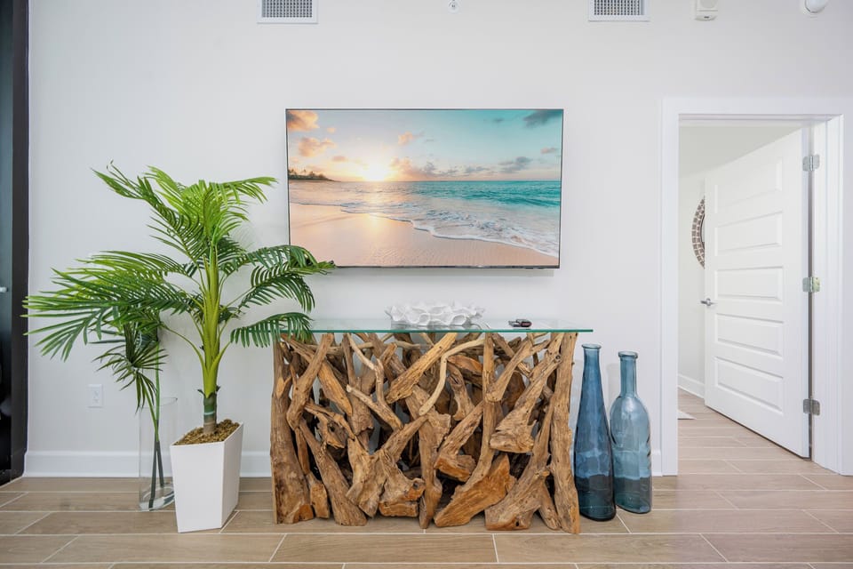Admire the beach decor and natural wood accents, creating a warm, inviting atmosphere in the living space