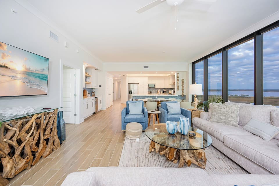Relax in the inviting living area with plush seating, a stylish coffee table, and stunning views