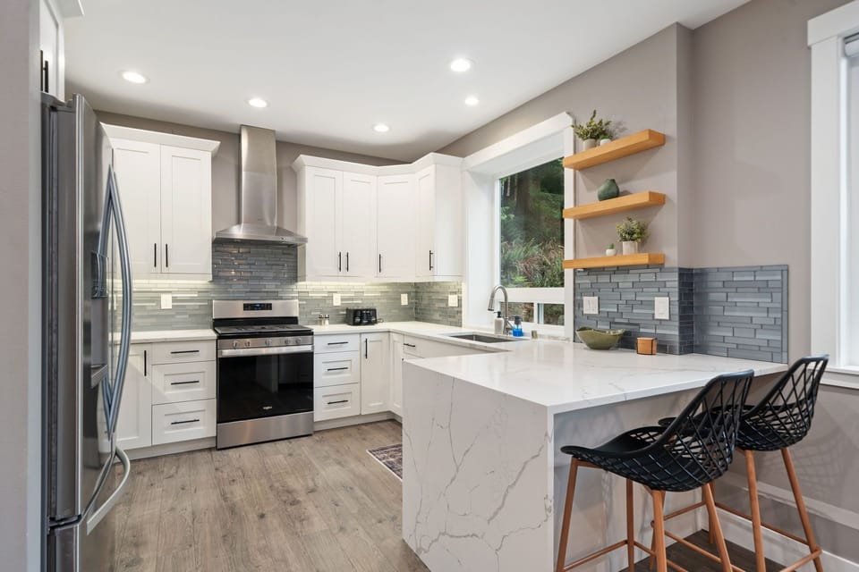 Your modern kitchen awaits with gleaming countertops, stainless appliances, and a perfect island for morning coffee or evening wine.
