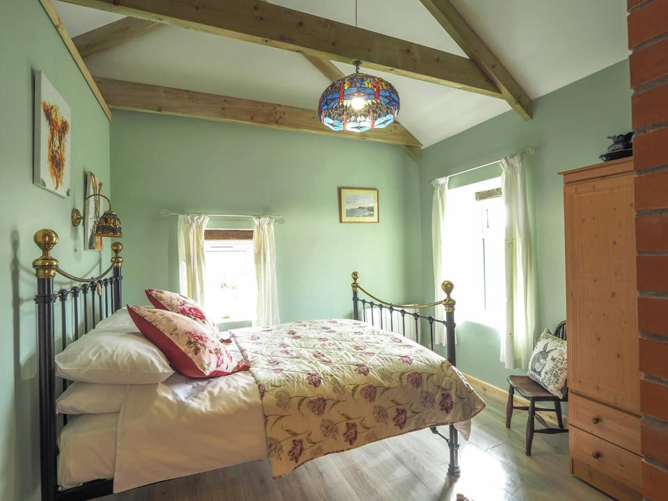 Double bed, wardrobe, chair, pictures on the wall