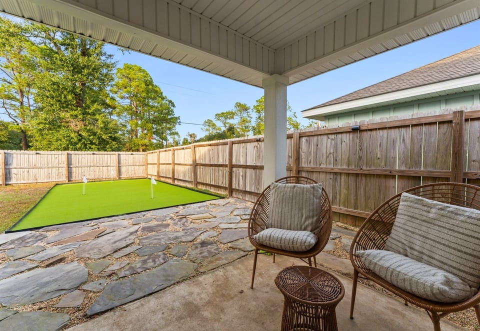 Covered patio seating creates a comfortable spot to enjoy morning coffee, casual meals, or a quiet evening outdoors.