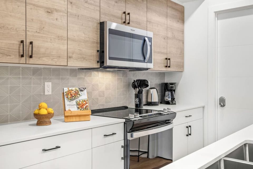 Modern and functional kitchen, ready to cater your culinary needs. Lemons and cookbook were used for only for photoshoot purposes.