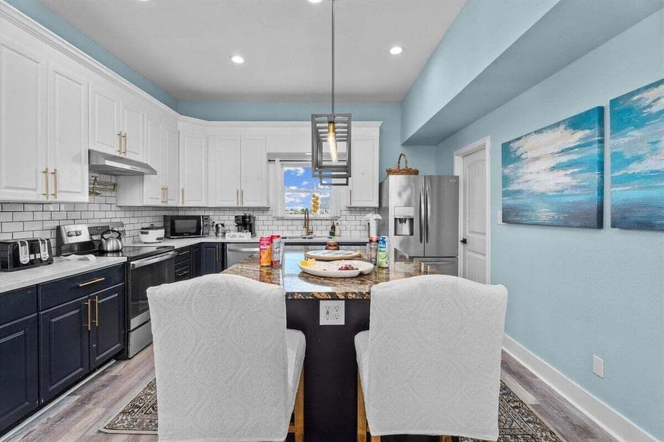 Kitchen with bar seating, pendant lighting, and open layout – ideal for entertaining guests.