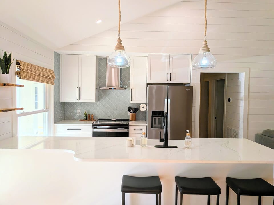 Step into a kitchen where modern minimalism meets lakeside warmth. 
