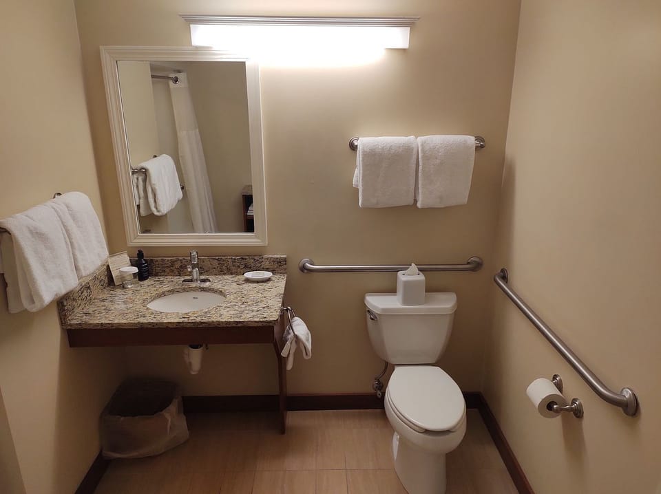 This private bath is designed with grab bars for safety, creating a fully accessible and comfortable experience to enhance your stay at Mount Snow.