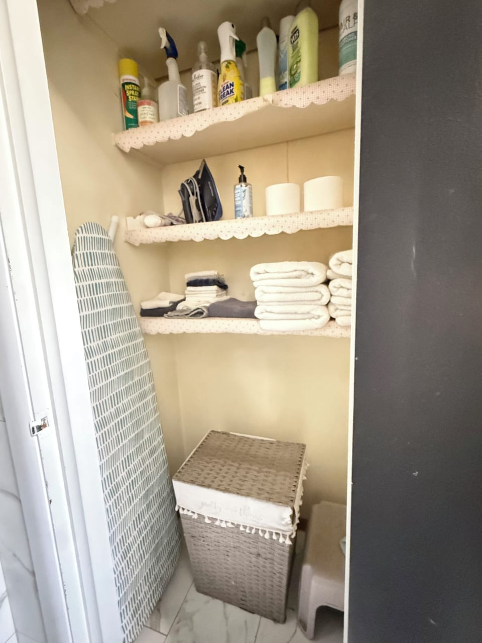 Bathroom Closet has Iron, Board, extra towels, toilet paper and laundry bin
