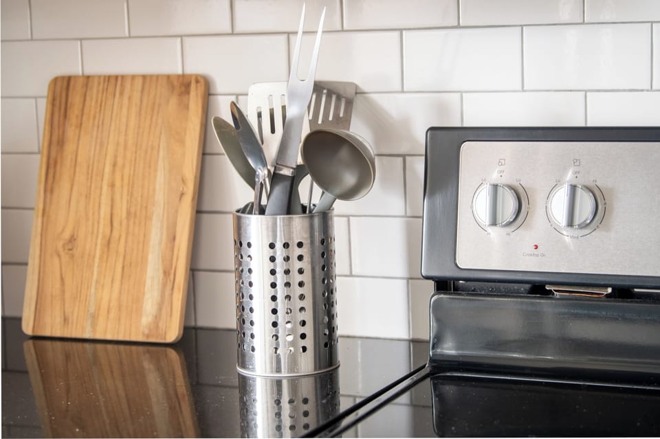 Thoughtful kitchen details with stainless utensils and quality cooking essentials.