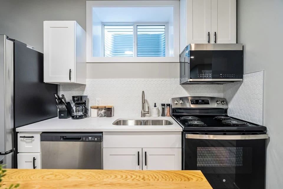 Full kitchen with a drip coffee machine, ground coffee, tea, sugar and basic condiments (ketchup, mustard and relish.)