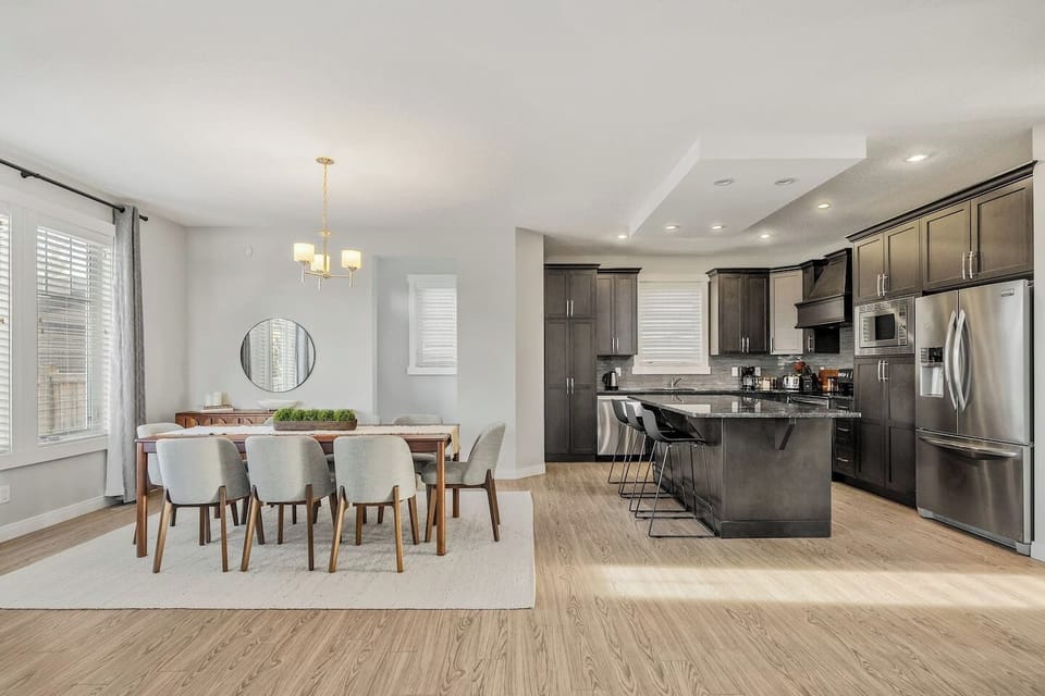 Expansive kitchen and dining area with seating for 8 at the table and 3 at the kitchen island.