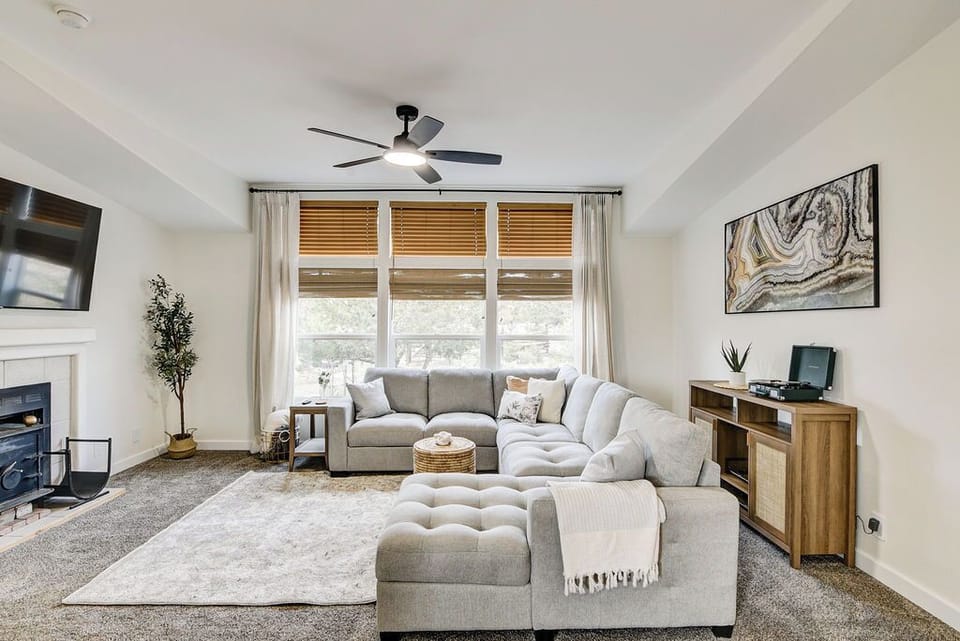 The living room features a large sectional sofa that pulls out into a queen bed.