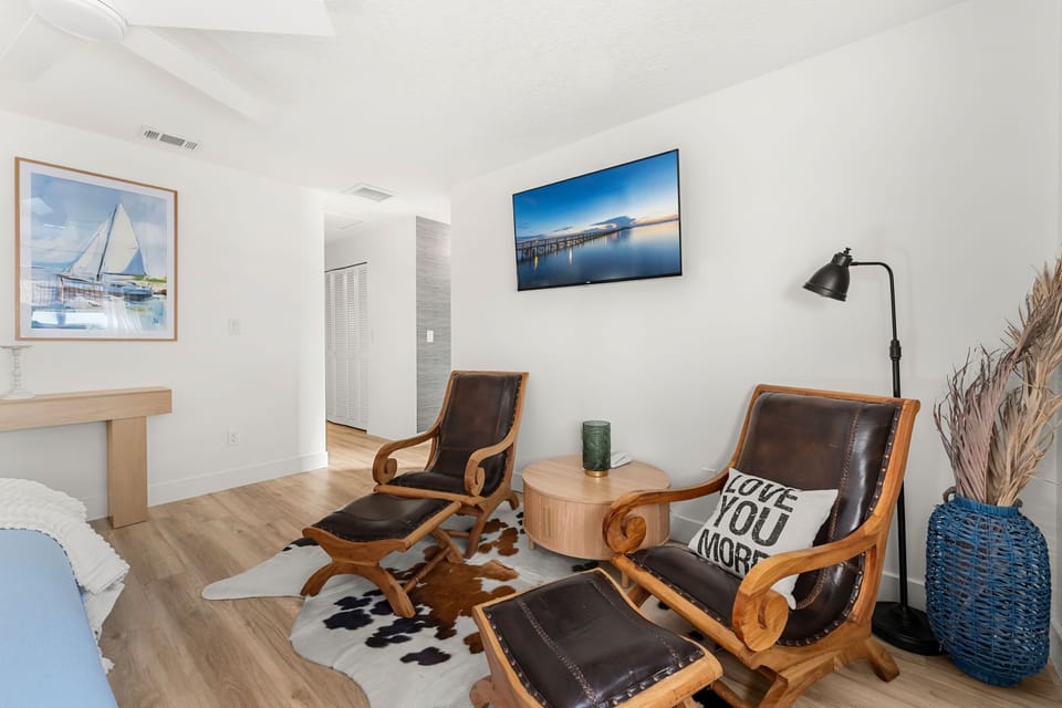Extra comfortable chairs in the master bedroom along with a smart TV