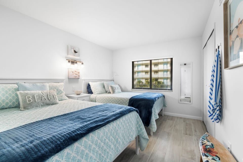 Guest bedroom features a two plush queen beds