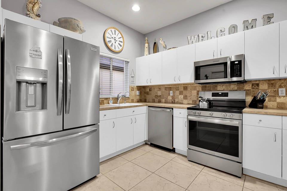 The kitchen is equipped with oven, microwave, refrigerator/freezer and dishwasher.