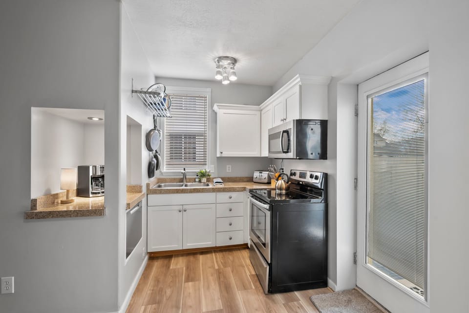 A full Galley Kitchen with dishwasher, Oven/Range, Microwave, Coffee Service and full size refrigerator