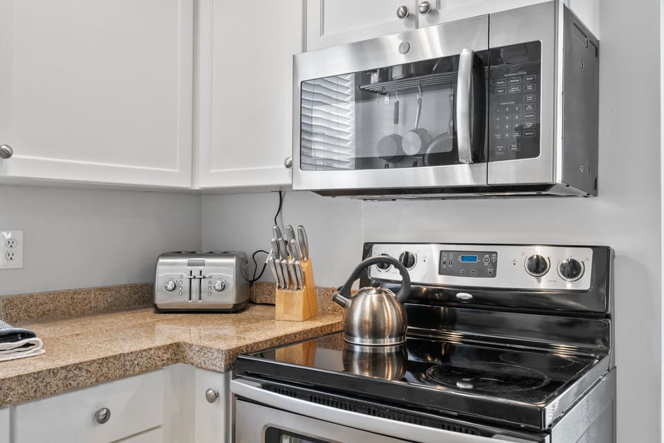 A full Galley Kitchen with dishwasher, Oven/Range, Microwave, Coffee Service and full size refrigerator