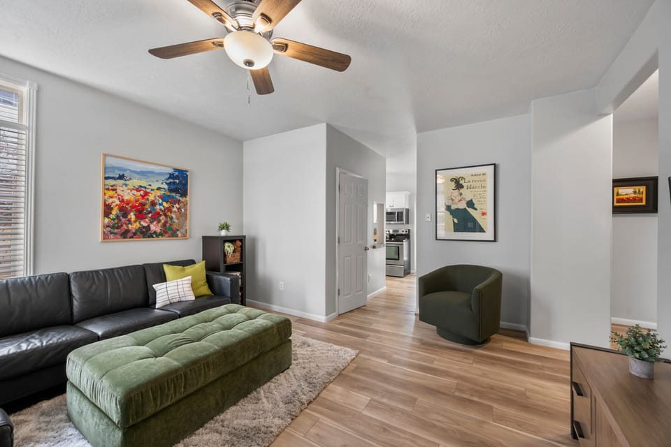 A comfy sectional, Ottoman and large Smart TV with stylish local artwork greet you as you enter the bungalow